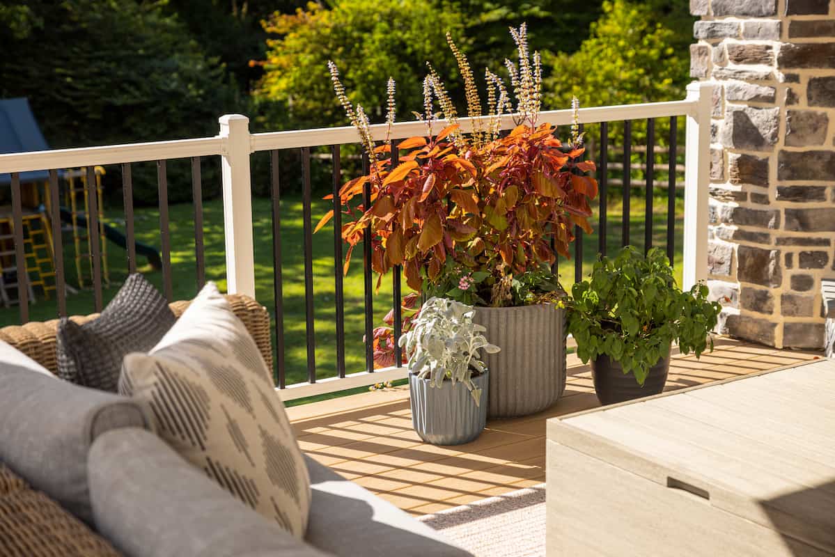 Key-Link American Series Aluminum Railing is featured on a deck with white railing and black balusters.