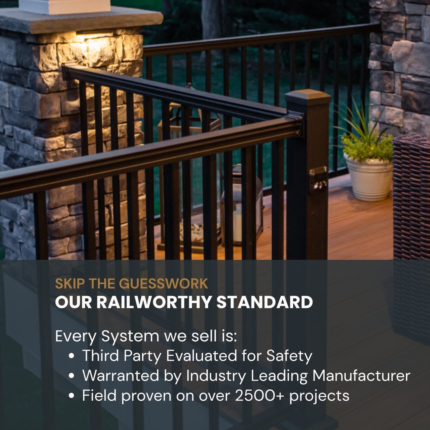 Black metal deck railing system installed on an outdoor wooden deck with stone pillars and a potted plant, featuring promotional text overlay.