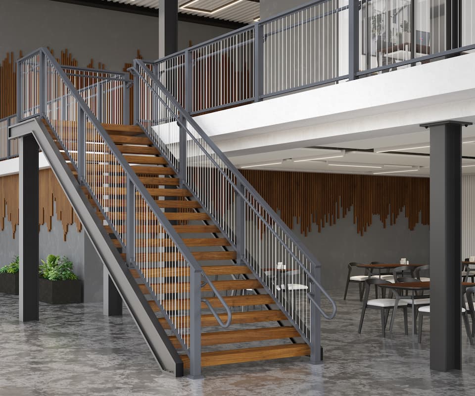 Staircase with wooden steps and aluminum vertical cable railing railing in a modern indoor setting with tables and chairs.