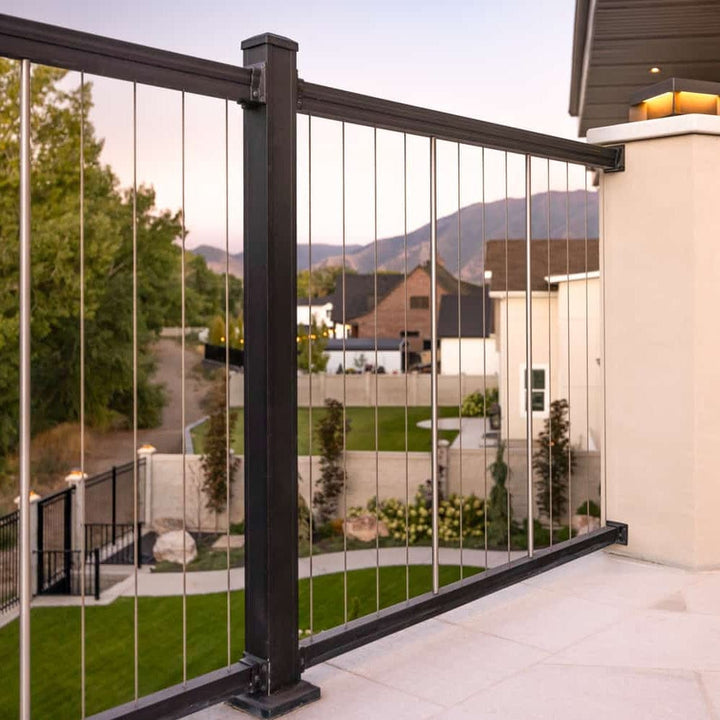 Key-Link vertical cable railing kit in matte black installed on a modern backyard deck at dusk